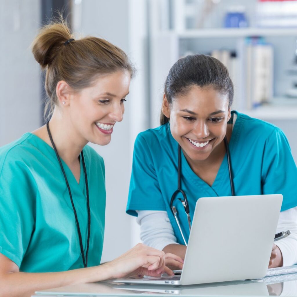 nurses looking at a computer